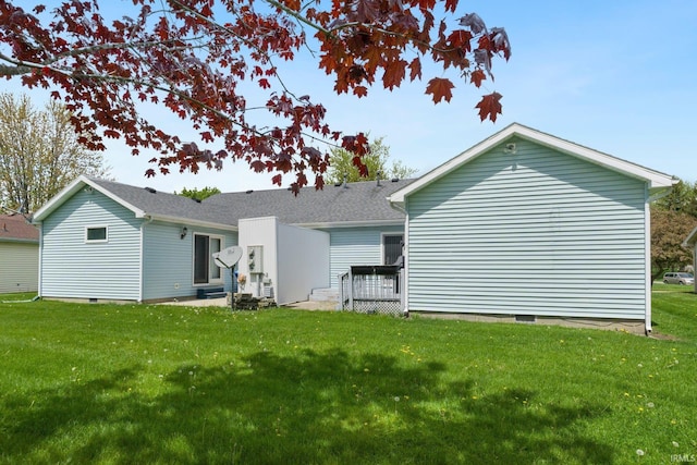 back of house with a yard and crawl space