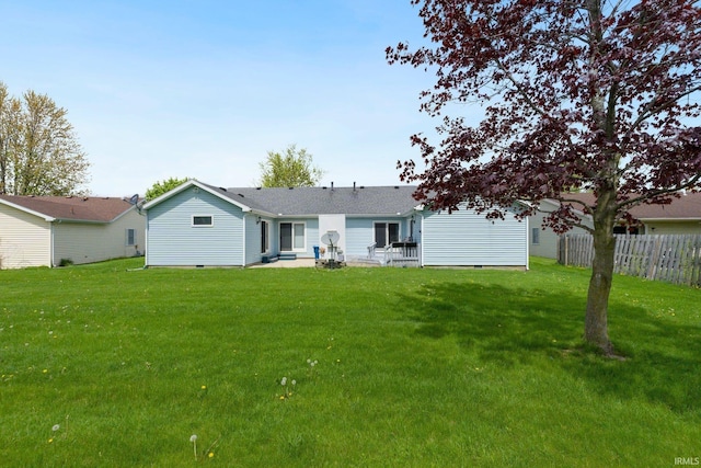 rear view of house featuring a yard, fence, a patio area, and crawl space