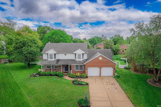 traditional home with concrete driveway, a front yard, a porch, and a garage