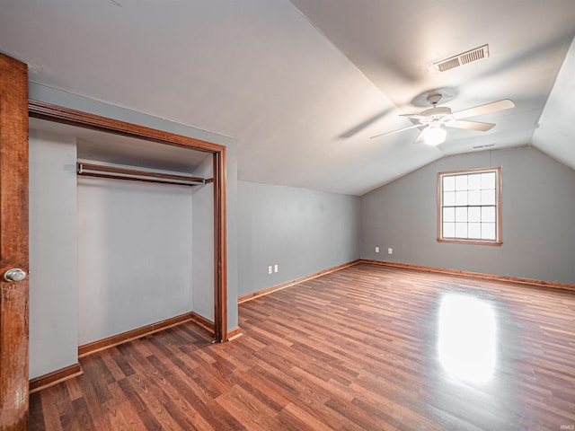 additional living space with baseboards, a ceiling fan, visible vents, and wood finished floors