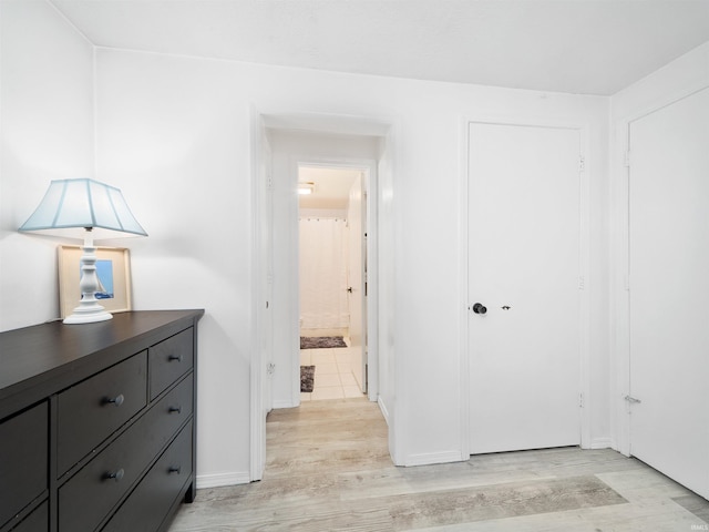 unfurnished bedroom with a closet and light wood-style flooring
