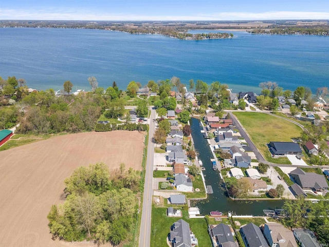 birds eye view of property featuring a water view and a residential view