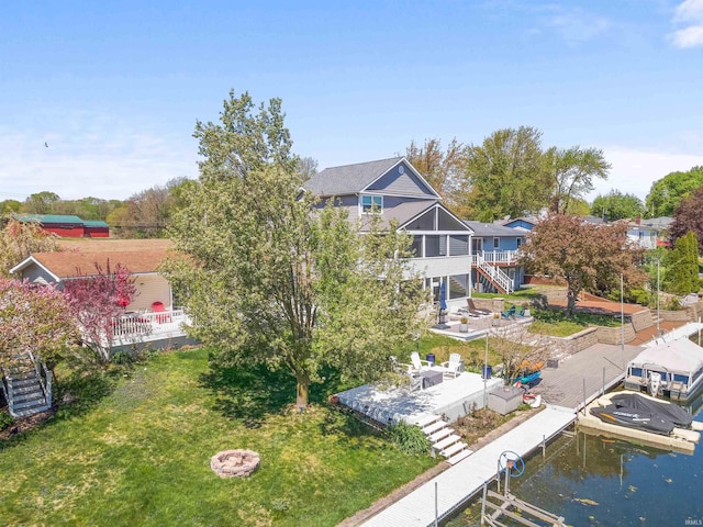 exterior space with a lawn, stairway, and boat lift