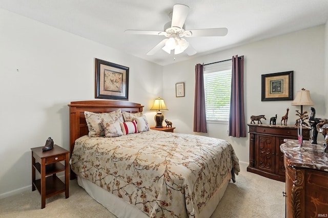 bedroom with ceiling fan, light carpet, and baseboards