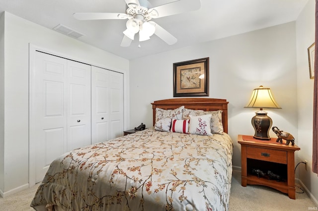 carpeted bedroom with ceiling fan, a closet, baseboards, and visible vents