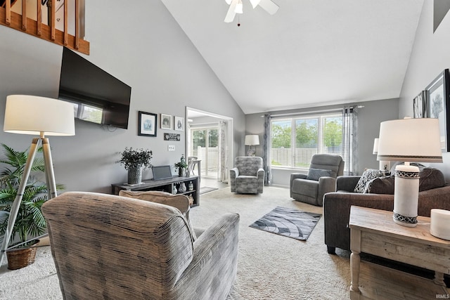 carpeted living area featuring ceiling fan and high vaulted ceiling