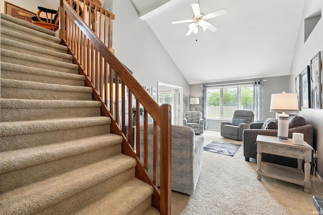 stairway with carpet flooring, high vaulted ceiling, and a ceiling fan