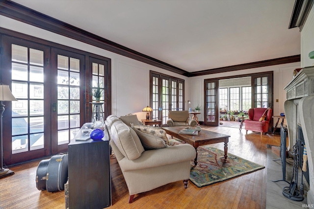 104 W Main St, Worthington, IN 47471 - living area with crown molding, french doors, a fireplace with flush hearth, and wood finished floors