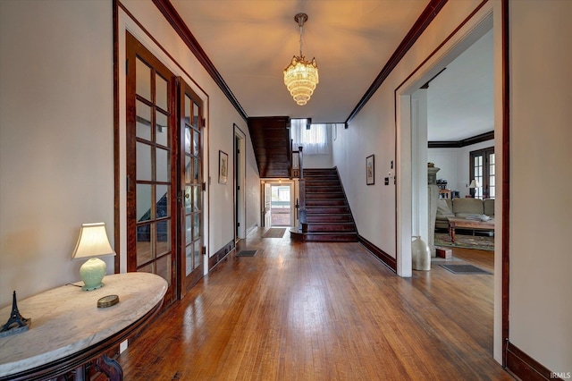 104 W Main St, Worthington, IN 47471 - foyer with crown molding, an inviting chandelier, wood finished floors, and stairs