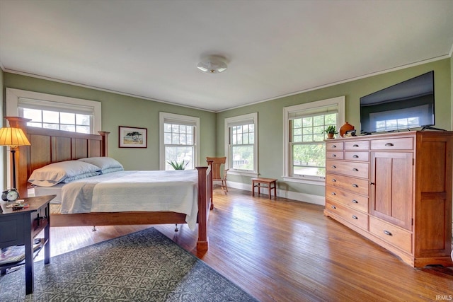 104 W Main St, Worthington, IN 47471 - bedroom with crown molding, light wood-style flooring, baseboards, and multiple windows