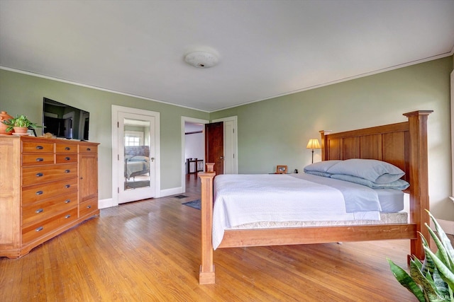 104 W Main St, Worthington, IN 47471 - bedroom with crown molding, light wood-style flooring, and baseboards