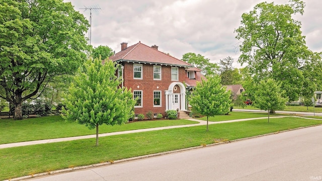104 W Main St, Worthington, IN 47471 - colonial inspired home with a front lawn, brick siding, and a chimney