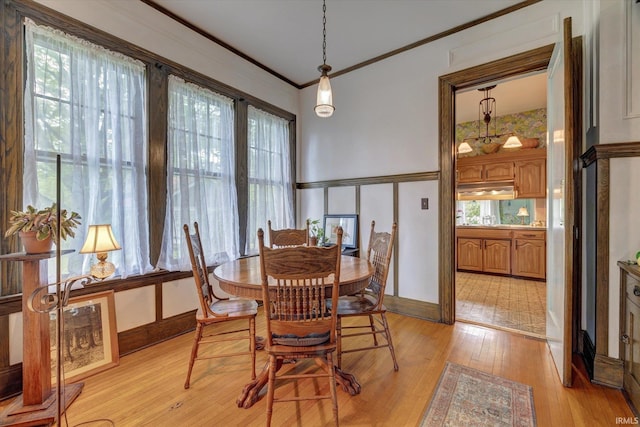 104 W Main St, Worthington, IN 47471 - dining space with light wood finished floors, crown molding, and a wainscoted wall