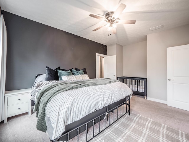 bedroom featuring ceiling fan, light carpet, and visible vents