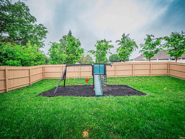 view of yard featuring a playground and a fenced backyard