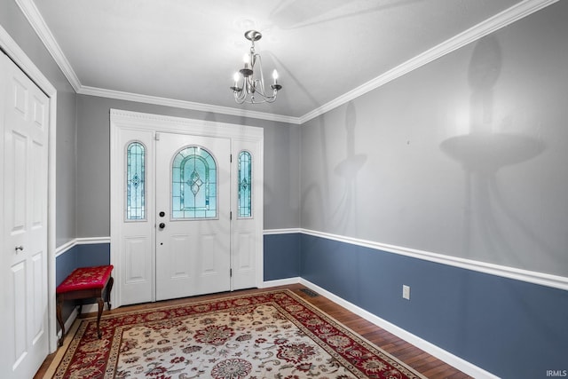 5259 E Willow Ct, Monticello, IN 47960 - foyer with crown molding, a chandelier, wood finished floors, and baseboards