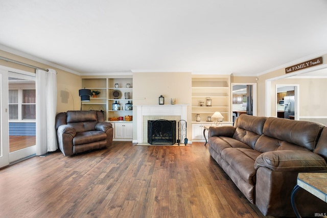 5259 E Willow Ct, Monticello, IN 47960 - living area featuring built in shelves, ornamental molding, a tile fireplace, and wood finished floors