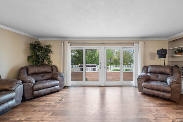 5259 E Willow Ct, Monticello, IN 47960 - living area with crown molding, french doors, a healthy amount of sunlight, and wood finished floors