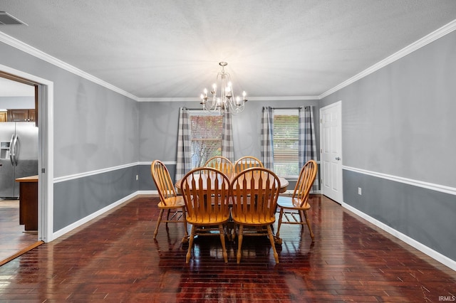 5259 E Willow Ct, Monticello, IN 47960 - dining space with crown molding, visible vents, an inviting chandelier, and wood-type flooring