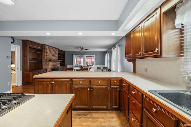 5259 E Willow Ct, Monticello, IN 47960 - kitchen featuring a ceiling fan, light countertops, a peninsula, and dark wood-style floors