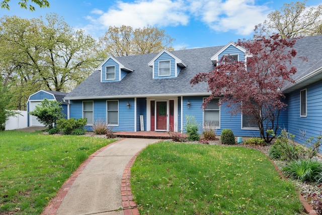 5259 E Willow Ct, Monticello, IN 47960 - new england style home featuring a porch, roof with shingles, and a front lawn