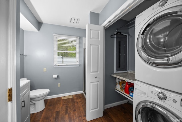 5259 E Willow Ct, Monticello, IN 47960 - clothes washing area with stacked washer and dryer, baseboards, visible vents, and dark wood finished floors