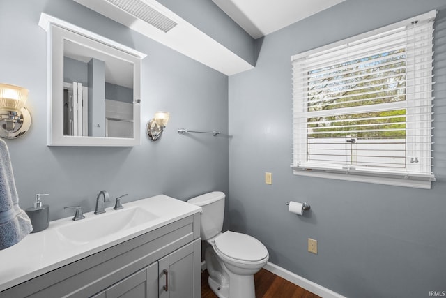 5259 E Willow Ct, Monticello, IN 47960 - bathroom featuring toilet, baseboards, visible vents, vanity, and wood finished floors