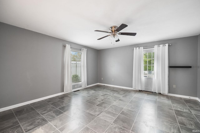 5259 E Willow Ct, Monticello, IN 47960 - unfurnished room featuring ceiling fan, baseboards, and plenty of natural light