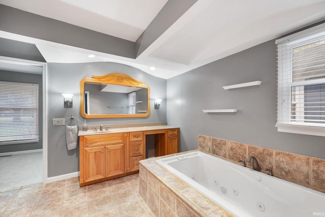 5259 E Willow Ct, Monticello, IN 47960 - bathroom featuring a wealth of natural light, baseboards, a jetted tub, and vanity