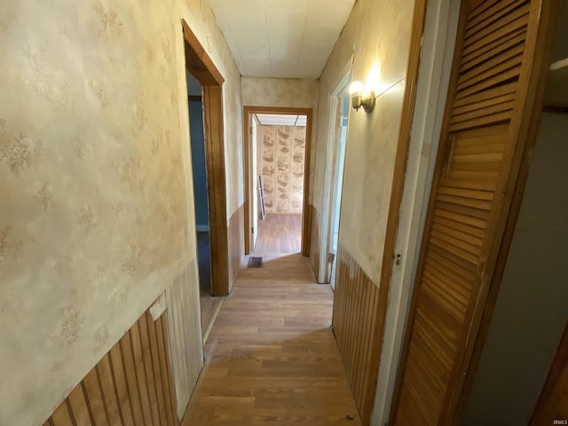 1514 Van Buren St, South Bend, IN 46628 - hallway with light wood finished floors, wallpapered walls, and visible vents