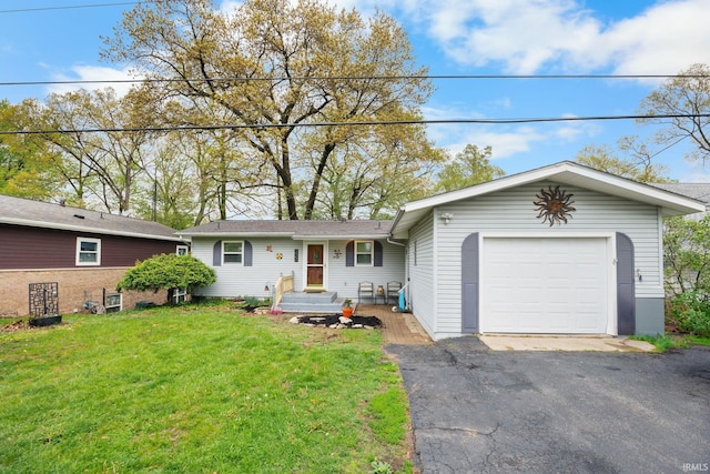 ranch-style home with a front lawn, an attached garage, and aphalt driveway