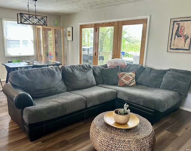 living room with dark wood-type flooring and baseboards