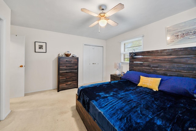 bedroom featuring a ceiling fan, baseboards, a closet, and carpet
