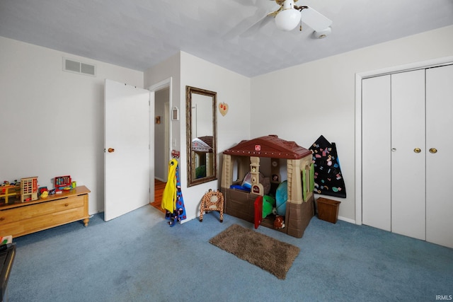 rec room with ceiling fan, visible vents, and carpet