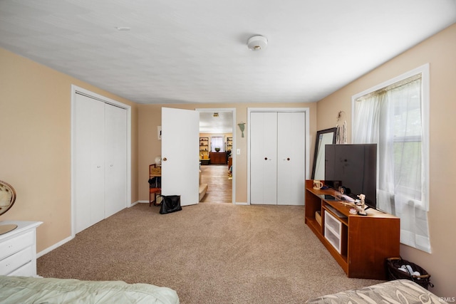 bedroom featuring two closets and carpet floors