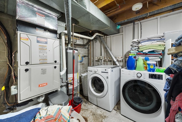 clothes washing area with laundry area, water heater, and independent washer and dryer