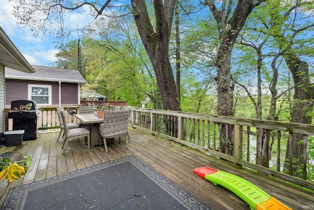 wooden deck featuring outdoor dining area and grilling area
