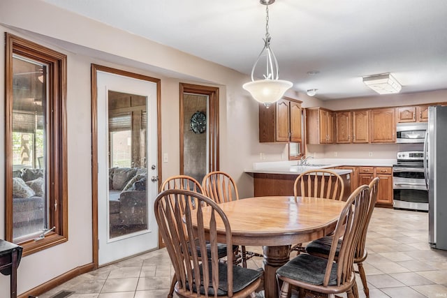 dining room featuring baseboards and light tile patterned floors