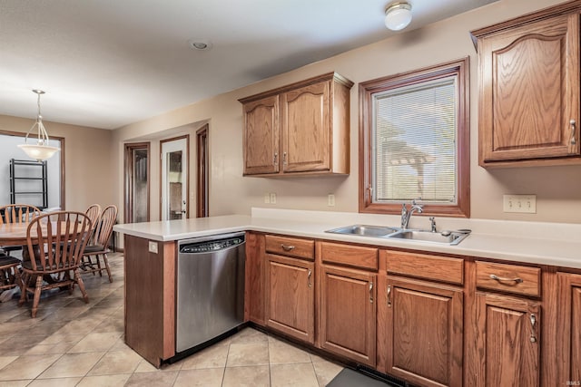 kitchen with dishwasher, light tile patterned floors, a sink, a peninsula, and light countertops