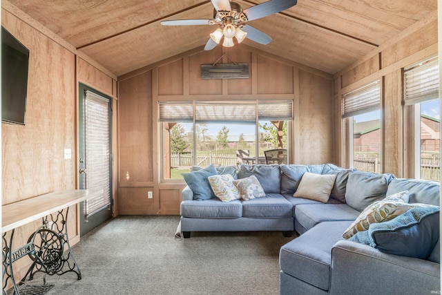 carpeted living area featuring vaulted ceiling, wooden walls, wood ceiling, and a ceiling fan