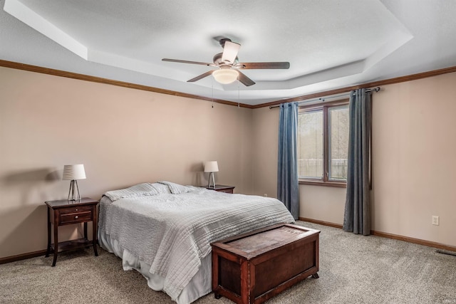 bedroom featuring a tray ceiling, baseboards, visible vents, ceiling fan, and light colored carpet