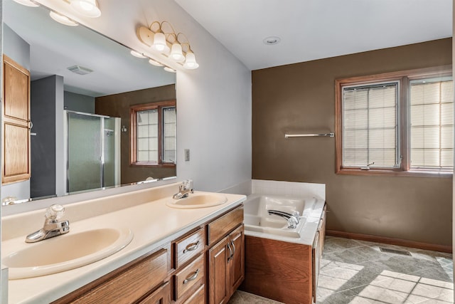 bathroom featuring a sink, double vanity, a shower stall, and a bath