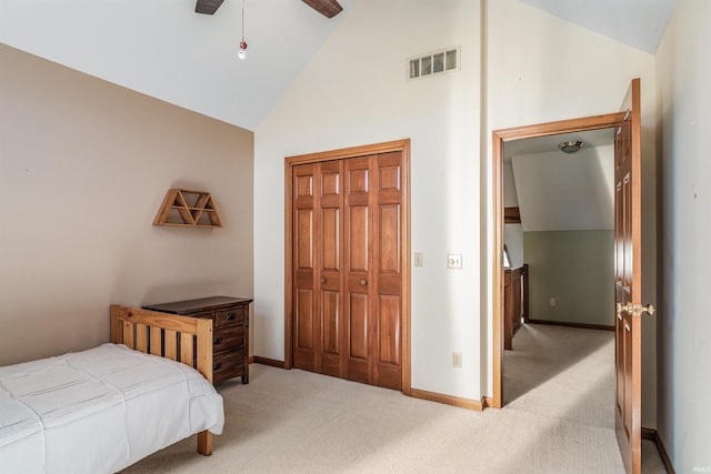 bedroom featuring baseboards, light carpet, visible vents, and high vaulted ceiling
