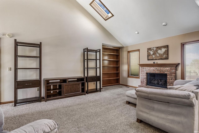 living room featuring carpet, a fireplace, a skylight, and high vaulted ceiling