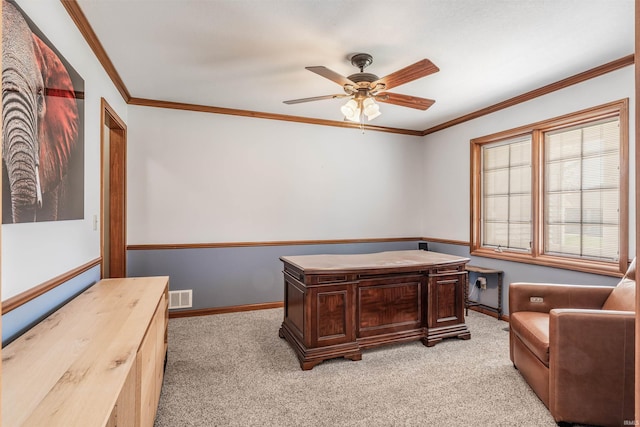 home office with light colored carpet, ornamental molding, visible vents, and ceiling fan