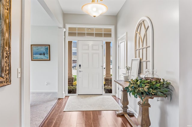 foyer with wood finished floors and baseboards