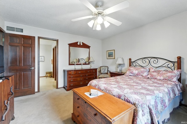bedroom featuring ceiling fan, light carpet, and visible vents