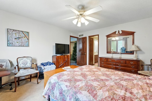 bedroom with ceiling fan, visible vents, and light colored carpet