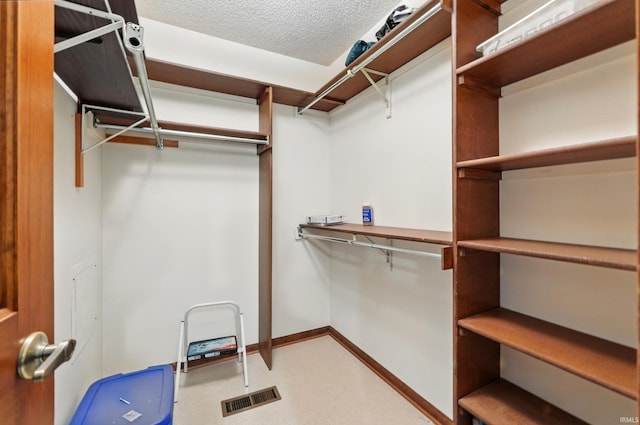 spacious closet featuring visible vents