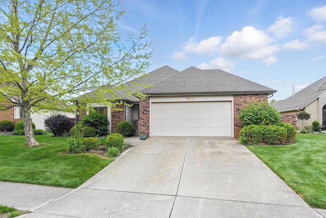 single story home with a garage, a shingled roof, brick siding, and a front yard